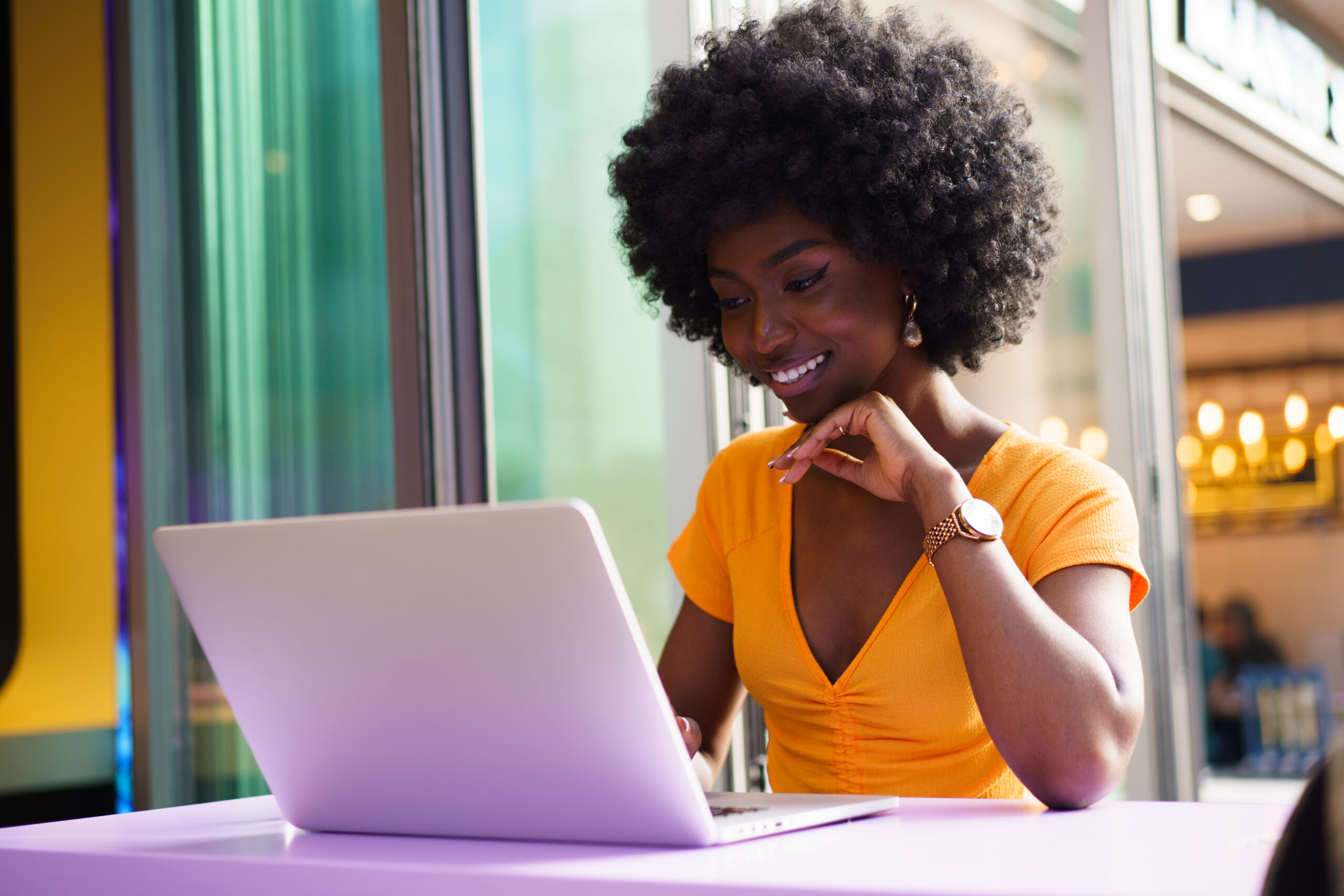 woman looking at the computer screen while smile