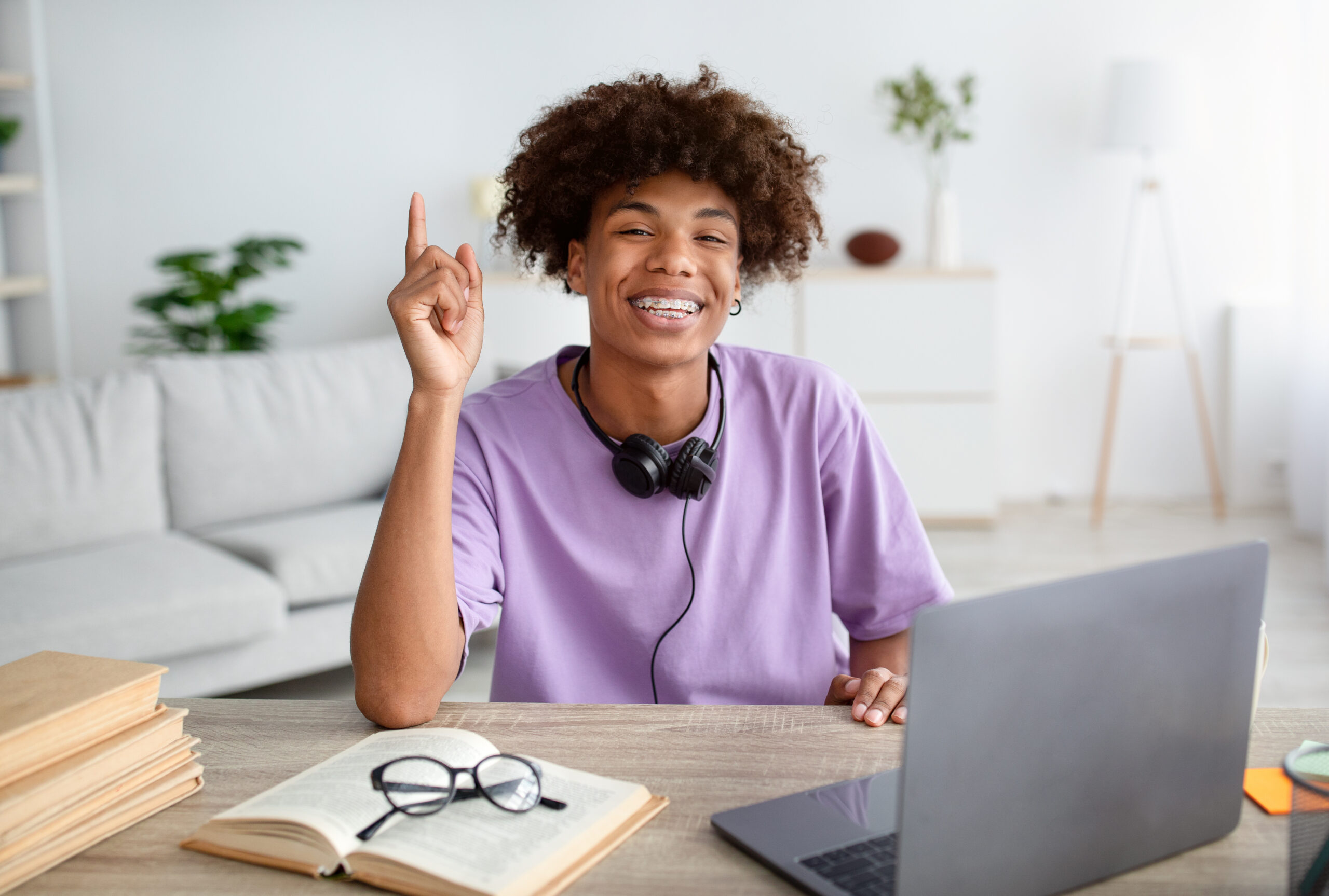 Happy teenage student in front of the computer